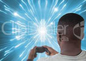 man playing with computer game controller with bright lights tunnel background