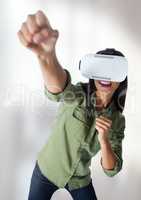 Businesswoman playing with virtual reality headset with bright background