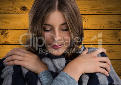 Woman against wood with warm scarf coat