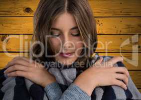 Woman against wood with warm scarf coat