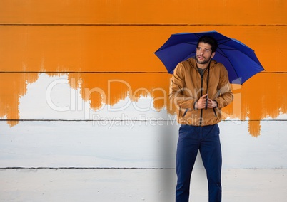 Man against wood with umbrella