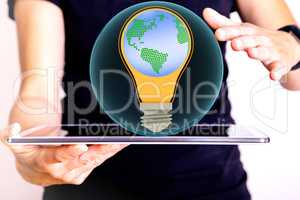 Man holding tablet pc with glass ball and light bulb