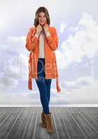 woman in orange coat with clouds