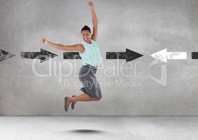 Businesswoman jumping with celebration and joy by arrows in opposite directions