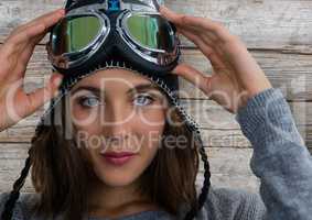 Woman against wood with ski snow glasses