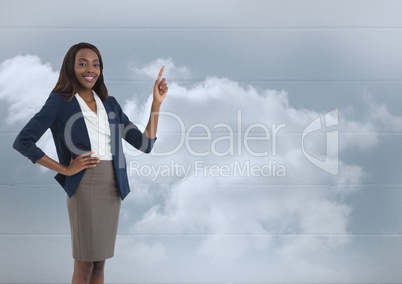 Businesswoman pointing with clouds