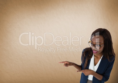 Businesswoman pointing with brown background