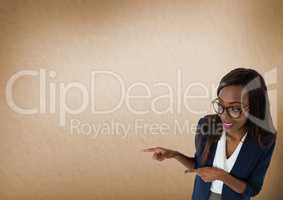 Businesswoman pointing with brown background