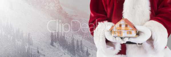 Santa Claus in Winter with home in hands