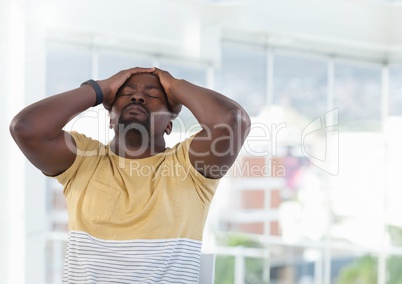Tired man at desk with bright background