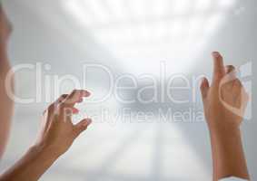 Hands interacting and touching air with bright background