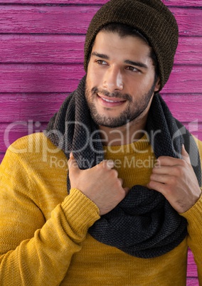 Man against wood with warm scarf and hat