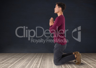 Man praying meditating on wooden floor