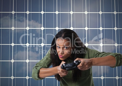 Businesswoman playing with computer game controller with squares background
