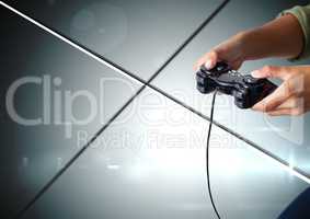 Hands playing with computer game controller with geometric minimal shiny lines background