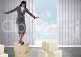Businesswoman balancing on boxes