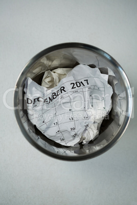 Crumpled calendar in dustbin