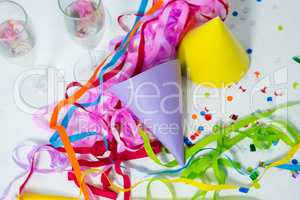 Champagne flutes with party hat and streamers