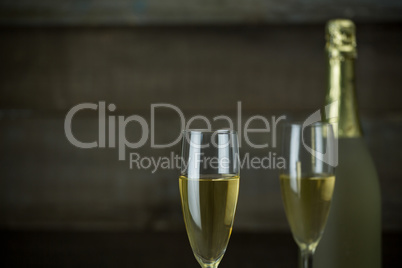 Glass of champagne with champagne bottle