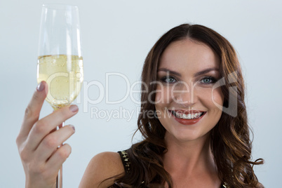 Smiling woman holding glass of champagne