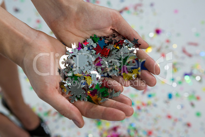 Woman holding snowflakes in hands