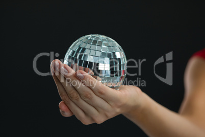 Woman holding mirror ball
