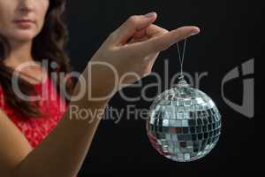 Woman holding mirror ball