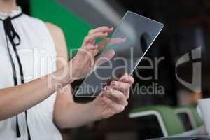 Male executive using glass digital tablet