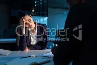Tensed businesswoman sitting at desk