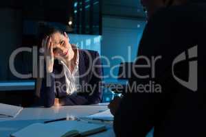 Tensed businesswoman sitting at desk