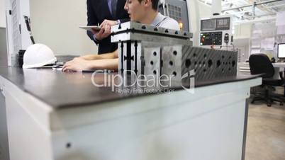 Men working at CNC factory