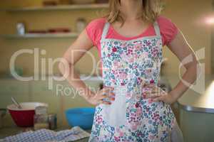 Waitress standing with hands on hip in restaurant