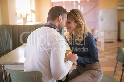 Couple romancing in restaurant