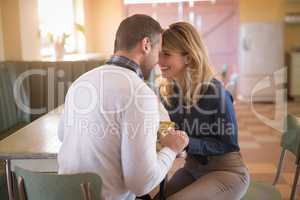Couple romancing in restaurant