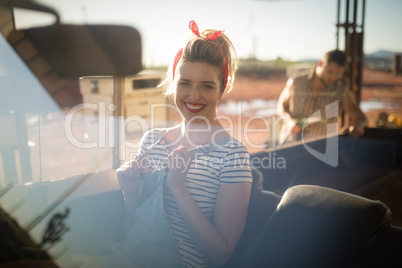 Woman sitting in car on a sunny day