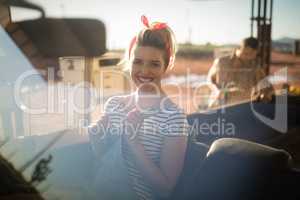 Woman sitting in car on a sunny day