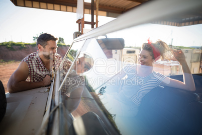 Couple with a car in petrol pump