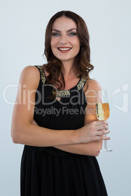 Smiling woman holding glass of champagne