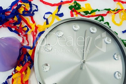 Clock and streamers against white background