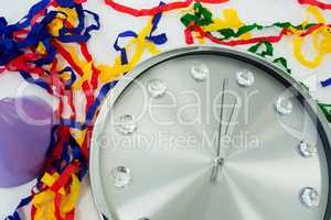 Clock and streamers against white background