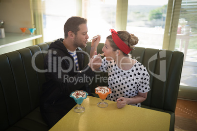 Couple feeding ice cream to each other