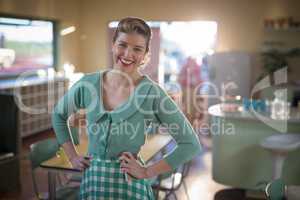 Waitress standing with hands on hips