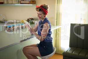 Woman using digital tablet in restaurant