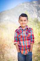 Mixed Race Young Boy Standing Outdoors.