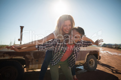 Man giving a piggyback ride to woman