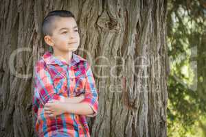 Mixed Race Young Boy Standing Outdoors.