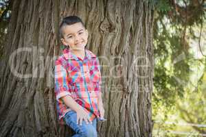 Mixed Race Young Boy Standing Outdoors.