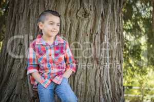 Mixed Race Young Boy Standing Outdoors.