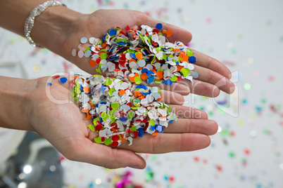 Woman holding confetti in hands