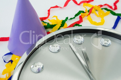 Clock and streamers against white background